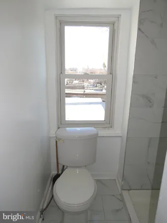 a view of a bathroom with wooden floor