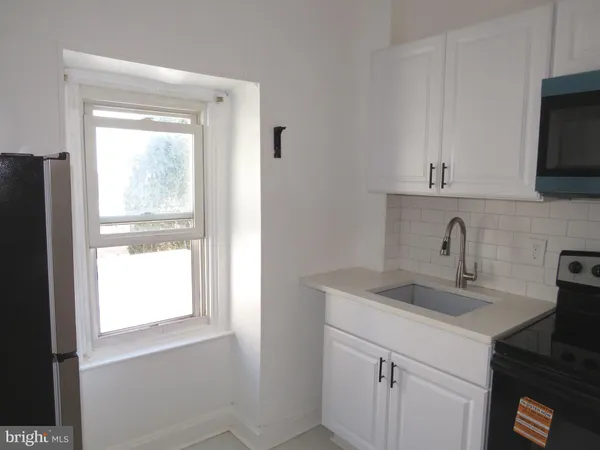 a kitchen with a sink and a window