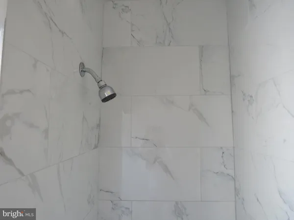 a white toilet sitting in a bathroom next to a window