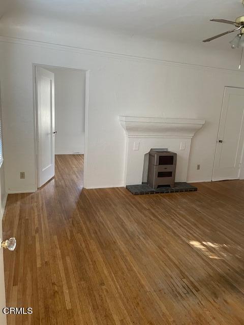 772 Poli Street, Unit E Ventura, CA 93001 - Photo 3 of 9 a view of empty room with wooden floor and fireplace