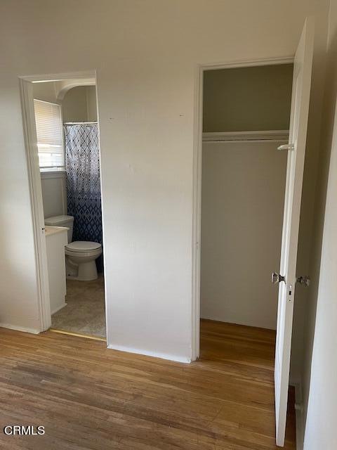 772 Poli Street, Unit E Ventura, CA 93001 - Photo 8 of 9 a view of a hallway with wooden floor and a bathroom