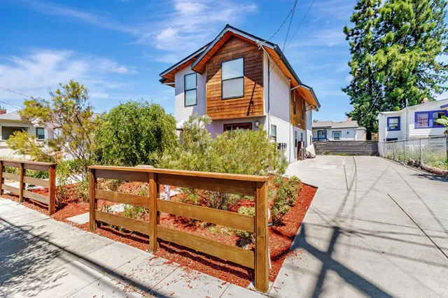 a view of a house with wooden fence