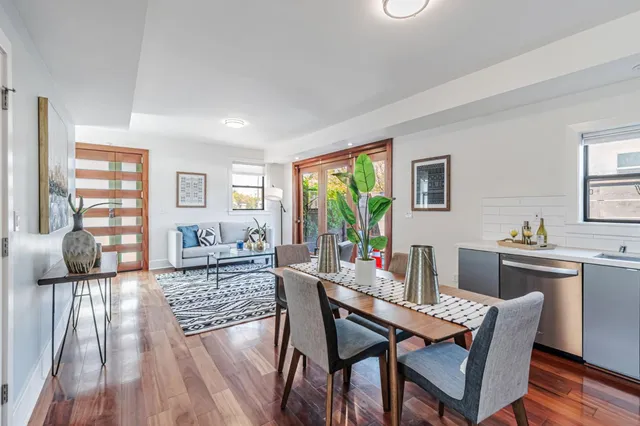 a dining room with furniture and wooden floor
