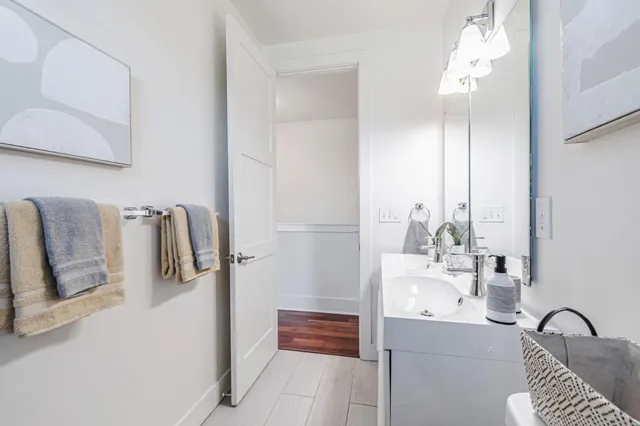 a bathroom with a bathtub sink and mirror