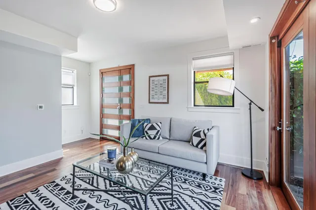 a living room with furniture and wooden floor