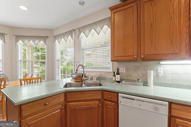 a kitchen with a sink cabinets and window