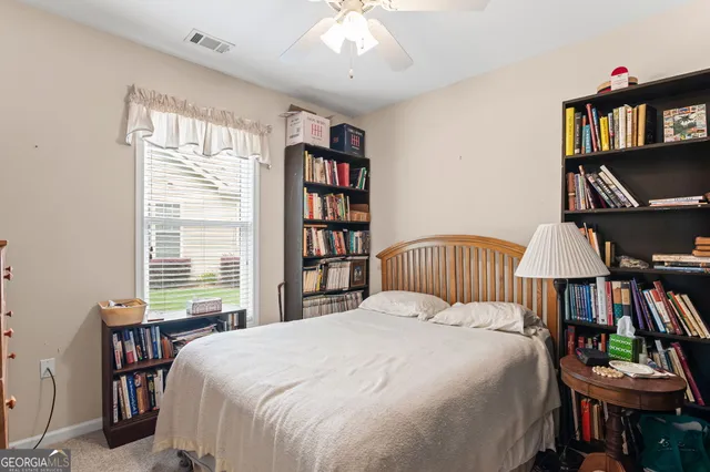 a bedroom with a bed and a book shelf