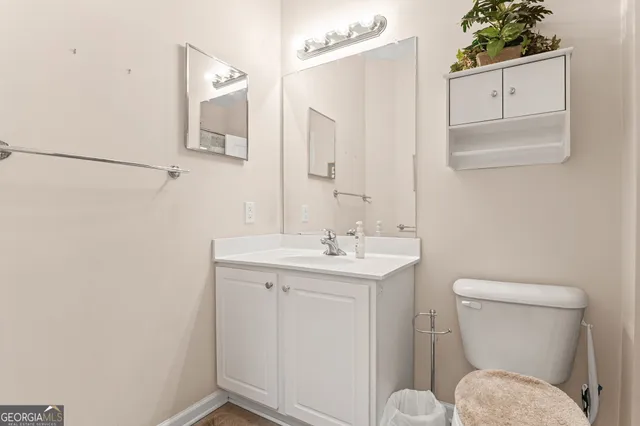 a bathroom with a toilet a sink and mirror