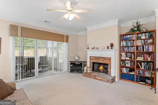 a living room with fireplace furniture and a book shelf