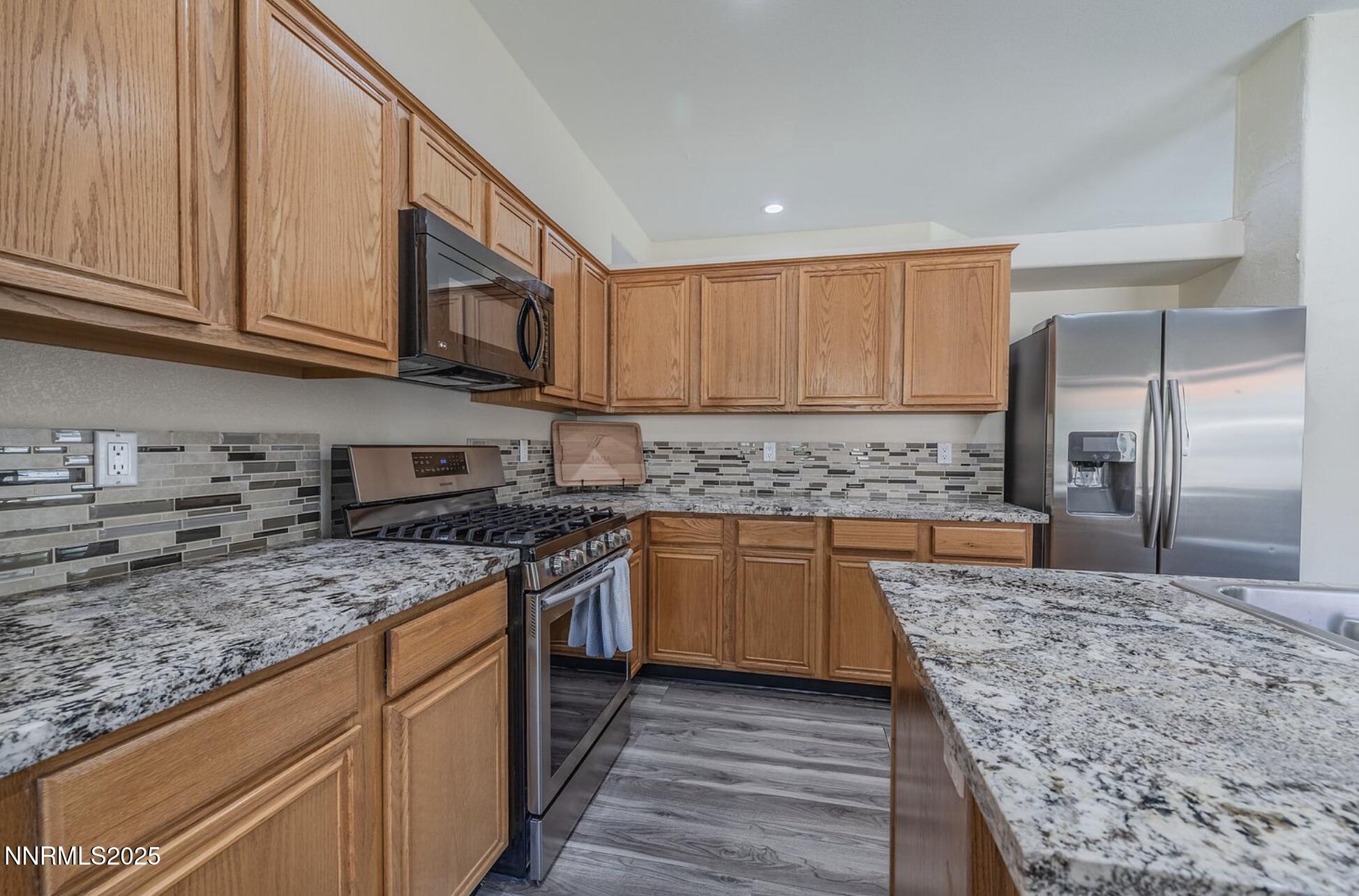 4080 Twin Falls Drive Reno, NV 89511 - Photo 6 of 16 a kitchen with stainless steel appliances granite countertop a stove sink and cabinets