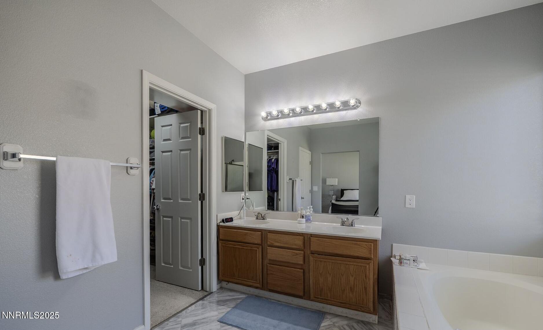 4080 Twin Falls Drive Reno, NV 89511 - Photo 9 of 16 a bathroom with a double vanity sink mirror and bathtub