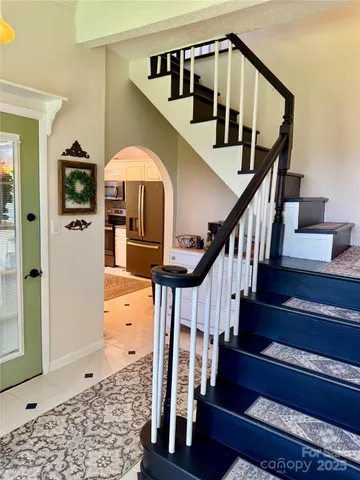 a view of entryway livingroom and hall with wooden floor