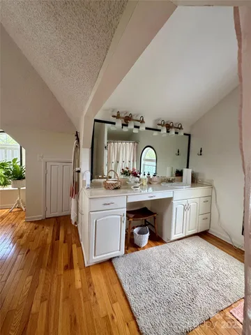 a kitchen with sink cabinets and stove top oven