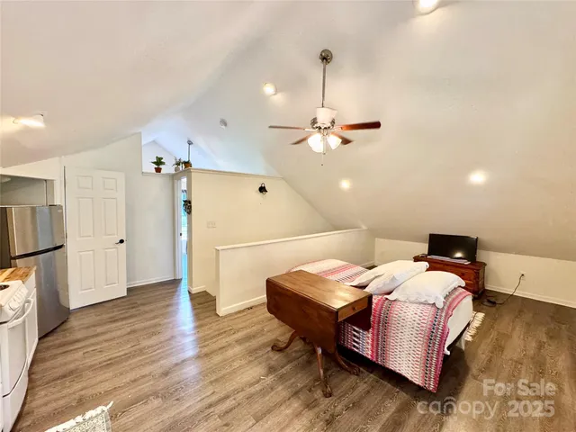 a bedroom with bed and a chandelier