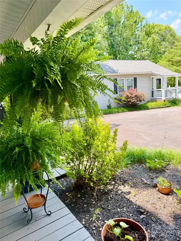 a dining room with furniture and a floor to ceiling window