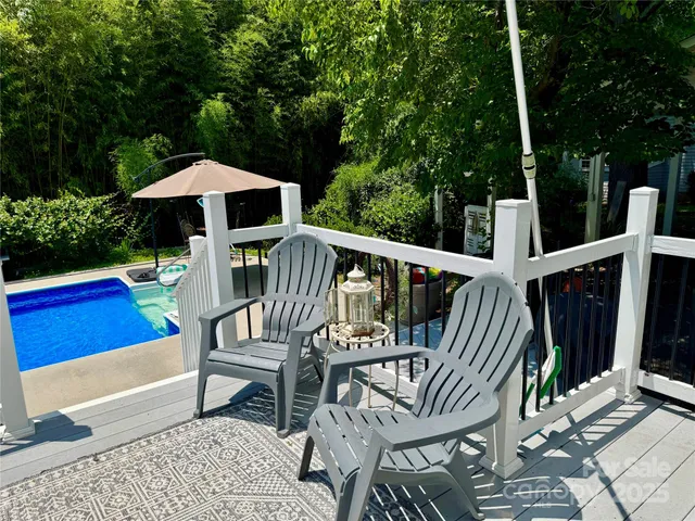 a view of pool table and chairs under an umbrella