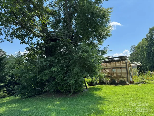 a view of a house with a backyard and a patio