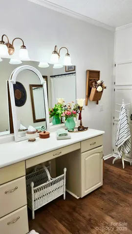 a view of kitchen with kitchen island stainless steel appliances and wooden floor