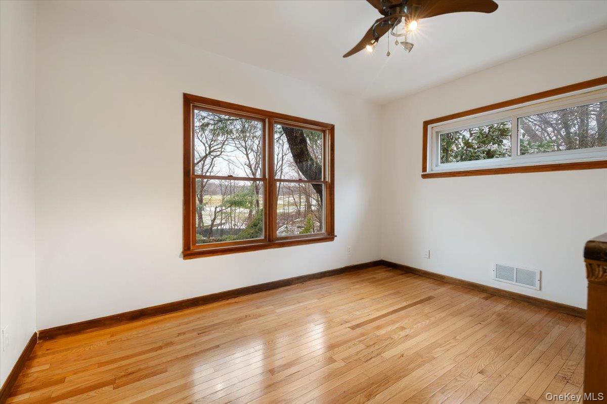 33 Fleets Cove Road Huntington, NY 11743 - Photo 21 of 42 Spare room with a ceiling fan, healthy amount of natural light, and light wood-style flooring