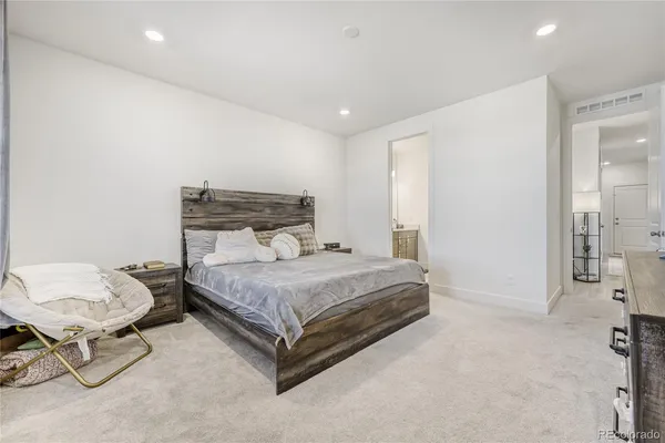 a bedroom with a bed and chair