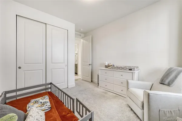 a bedroom with furniture and white walls