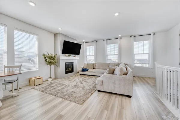 a living room with furniture fireplace and flat screen tv