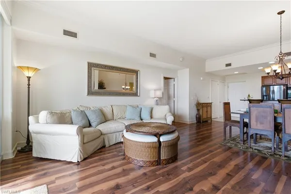 a living room with furniture and a floor to ceiling window