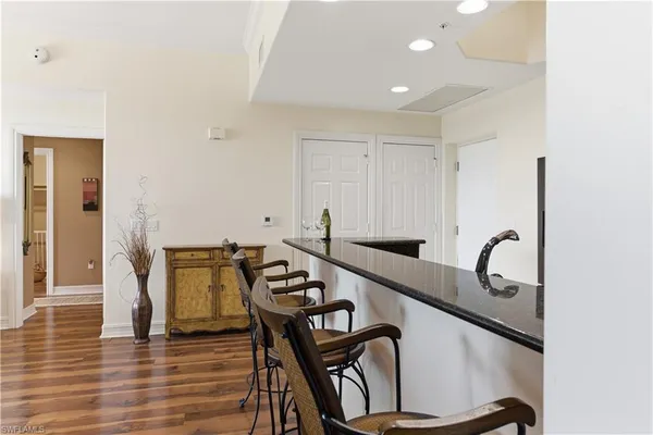 a living room with furniture a chandelier and a window