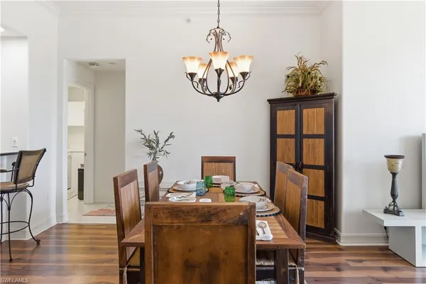 a view of a dining room with furniture kitchen and wooden floor