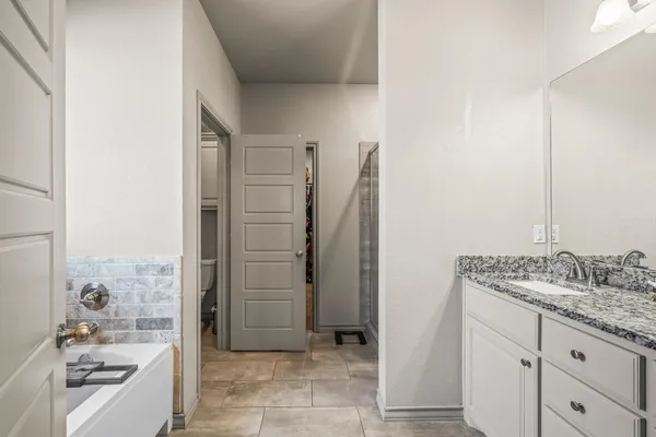 a bathroom with a tub and a sink