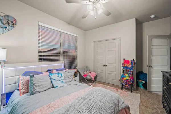 a bedroom with a bed and flat screen tv