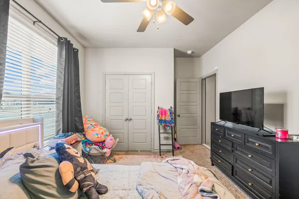 a bedroom with a bed and dresser