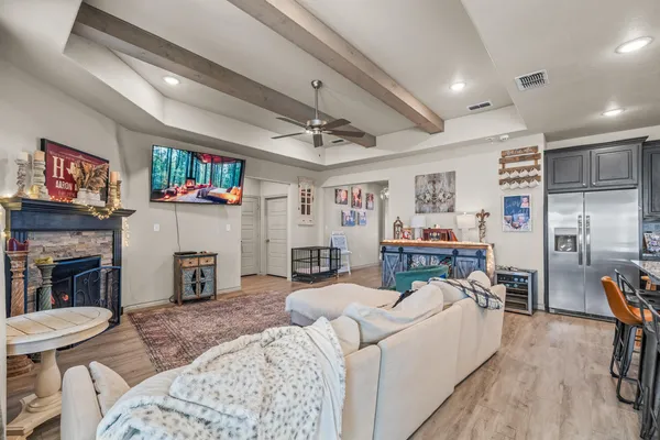 a living room with fireplace furniture and a flat screen tv