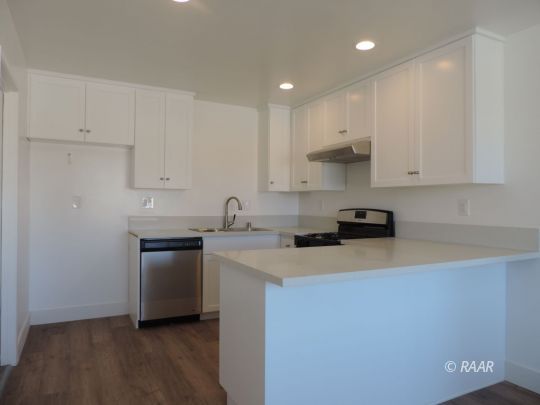 709 West Alene Avenue Ridgecrest, CA 93555 - Photo 6 of 20 a kitchen with stainless steel appliances granite countertop a sink stove and refrigerator