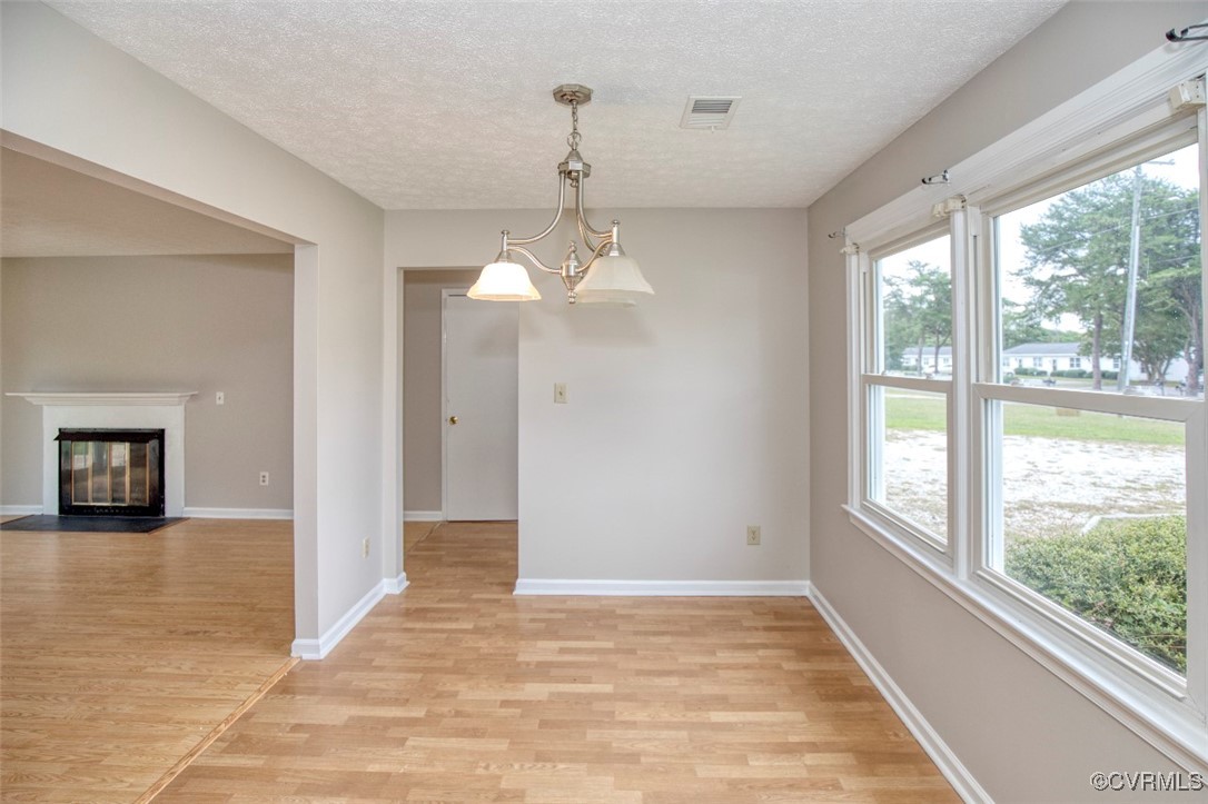 7579 Bellehaven Drive Gloucester Point, VA 23062 - Photo 3 of 13 a view of a big room with wooden floor windows and chandelier