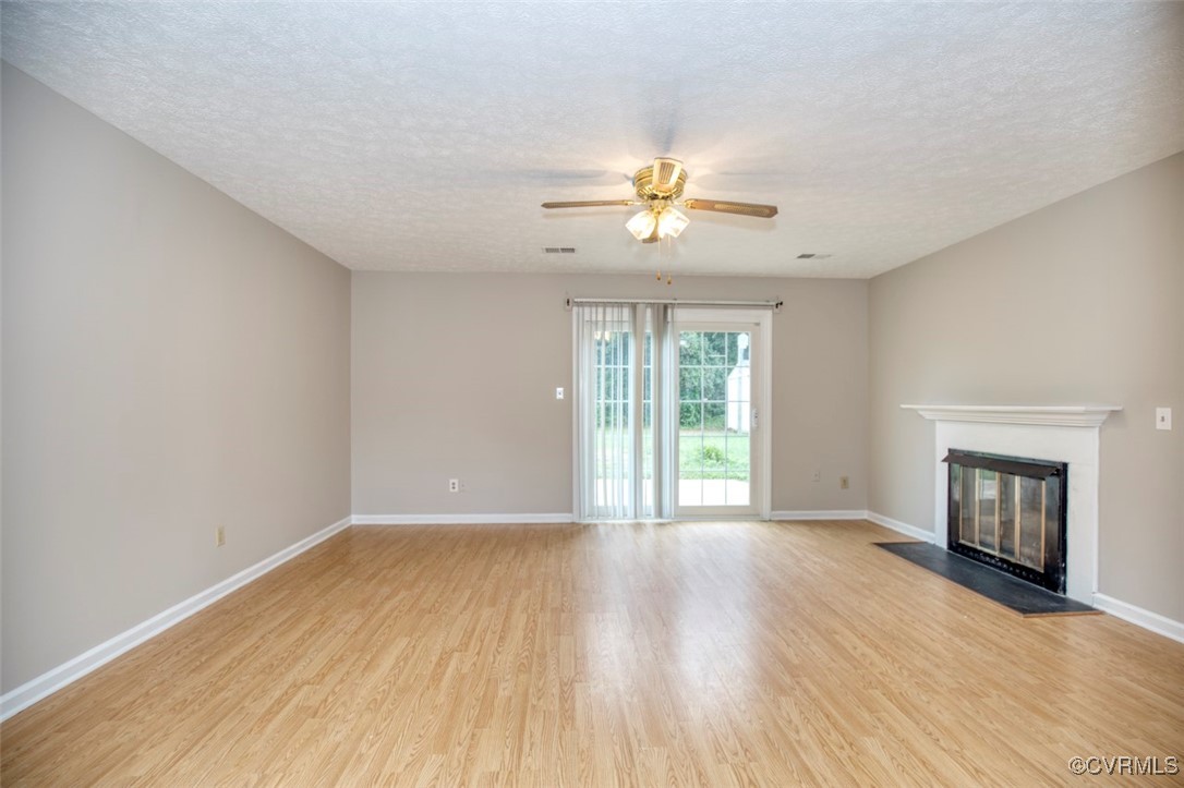 7579 Bellehaven Drive Gloucester Point, VA 23062 - Photo 7 of 13 a view of an empty room with a fireplace and a window