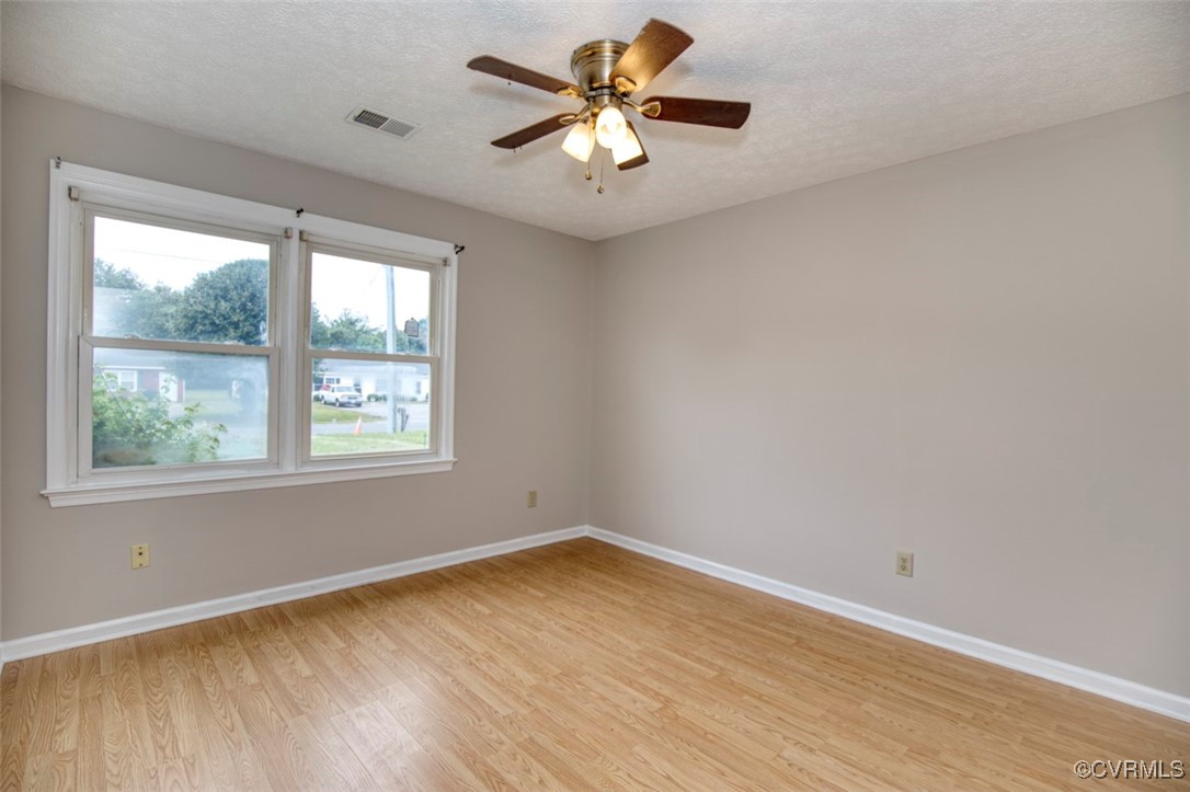7579 Bellehaven Drive Gloucester Point, VA 23062 - Photo 9 of 13 wooden floor in an empty room with a window