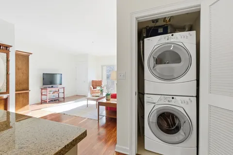 a living room with furniture and a washer dryer