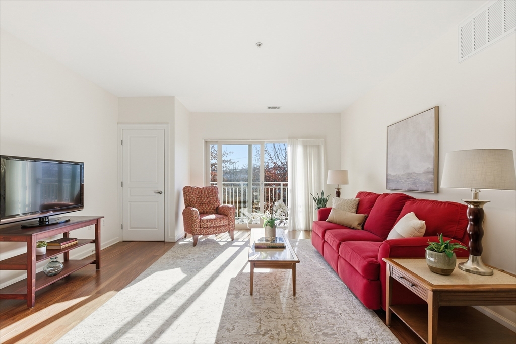 3 Repton Place, Unit 3204 Watertown, MA 02472 - Photo 2 of 18 a living room with furniture and a flat screen tv