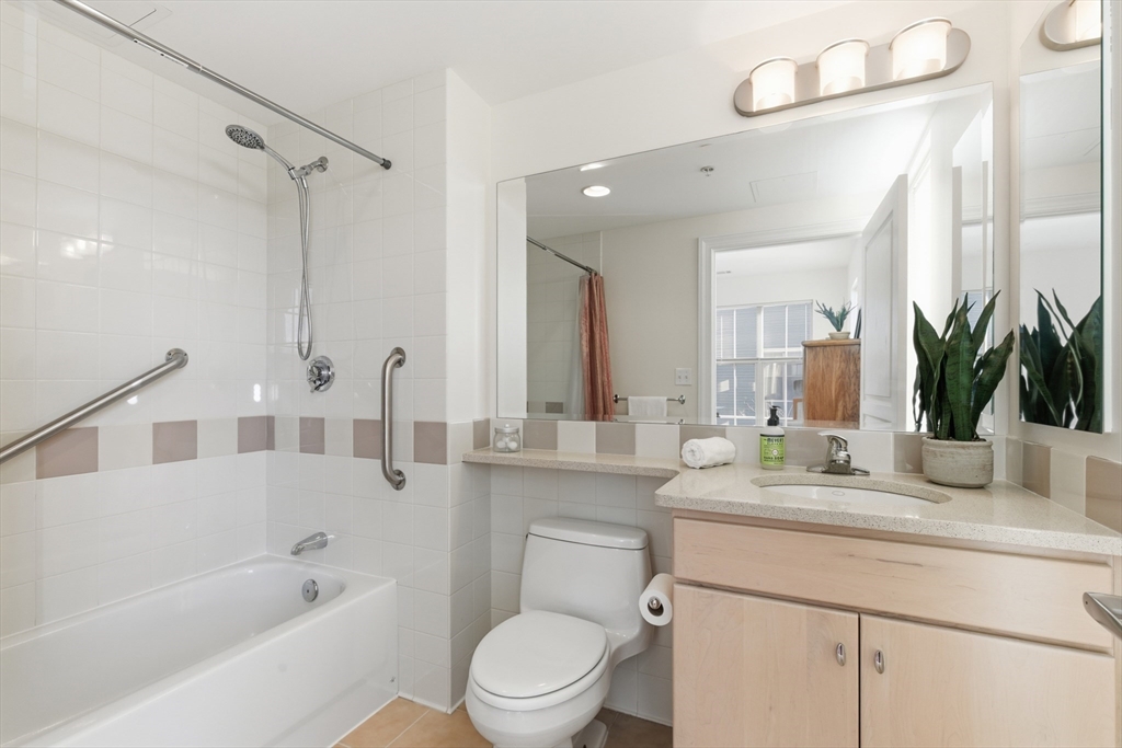 3 Repton Place, Unit 3204 Watertown, MA 02472 - Photo 10 of 18 a bathroom with a granite countertop sink mirror toilet and bathtub