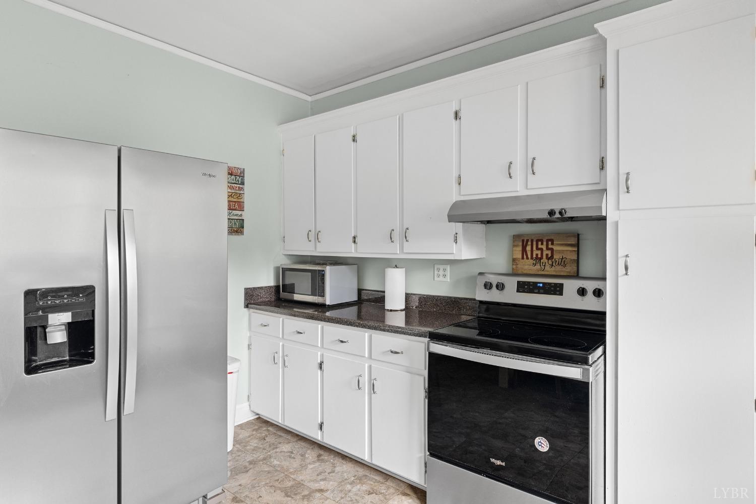 65 Phoenix Road Arrington, VA 22922 - Photo 18 of 58 a kitchen with granite countertop white cabinets and stainless steel appliances