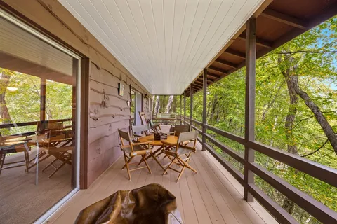 a view of balcony with chairs and wooden floor