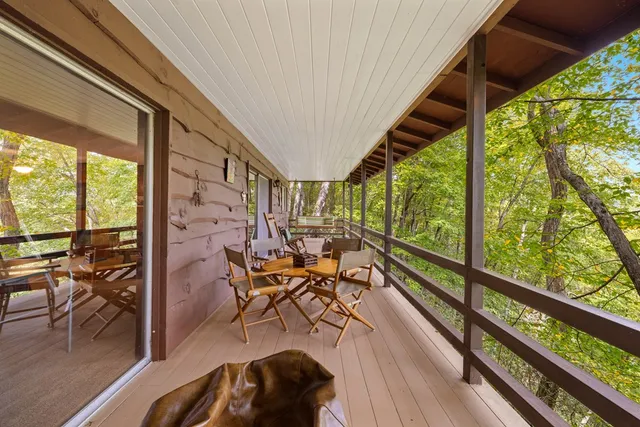 a view of balcony with chairs and wooden floor
