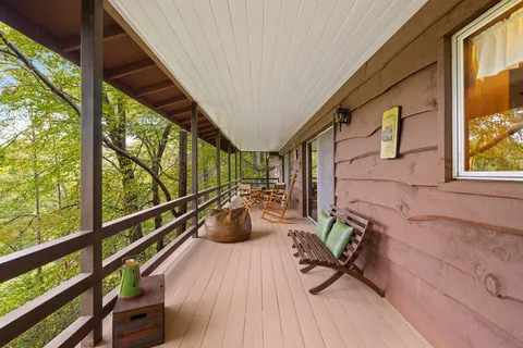a view of balcony with chairs and wooden floor
