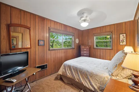 a bedroom with bunk bed and a window