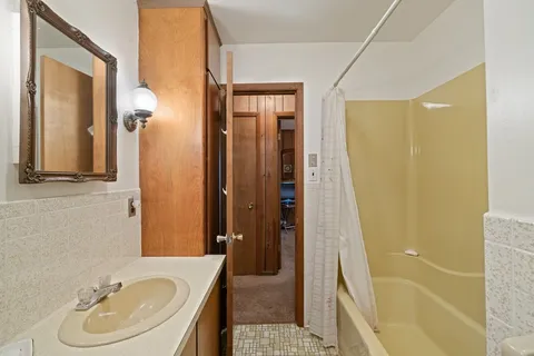 a bathroom with a granite countertop sink toilet and a mirror