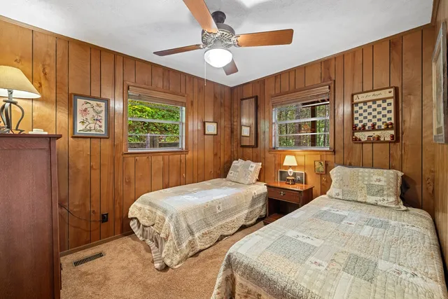 a view of a bedroom with closet and mirror