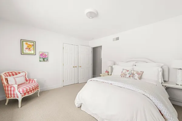 a bedroom with a bed and a couch