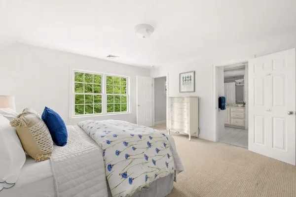 a bedroom with furniture and a window