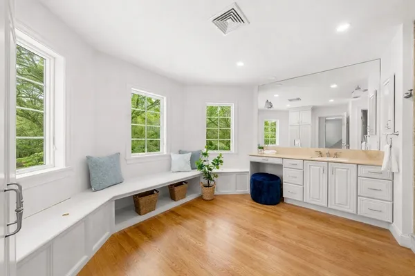 a large white kitchen with a large window